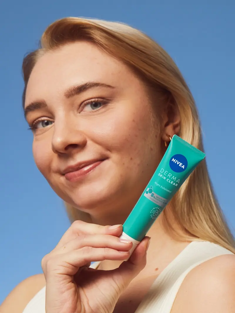 young woman using NIVEA DermaSkin product