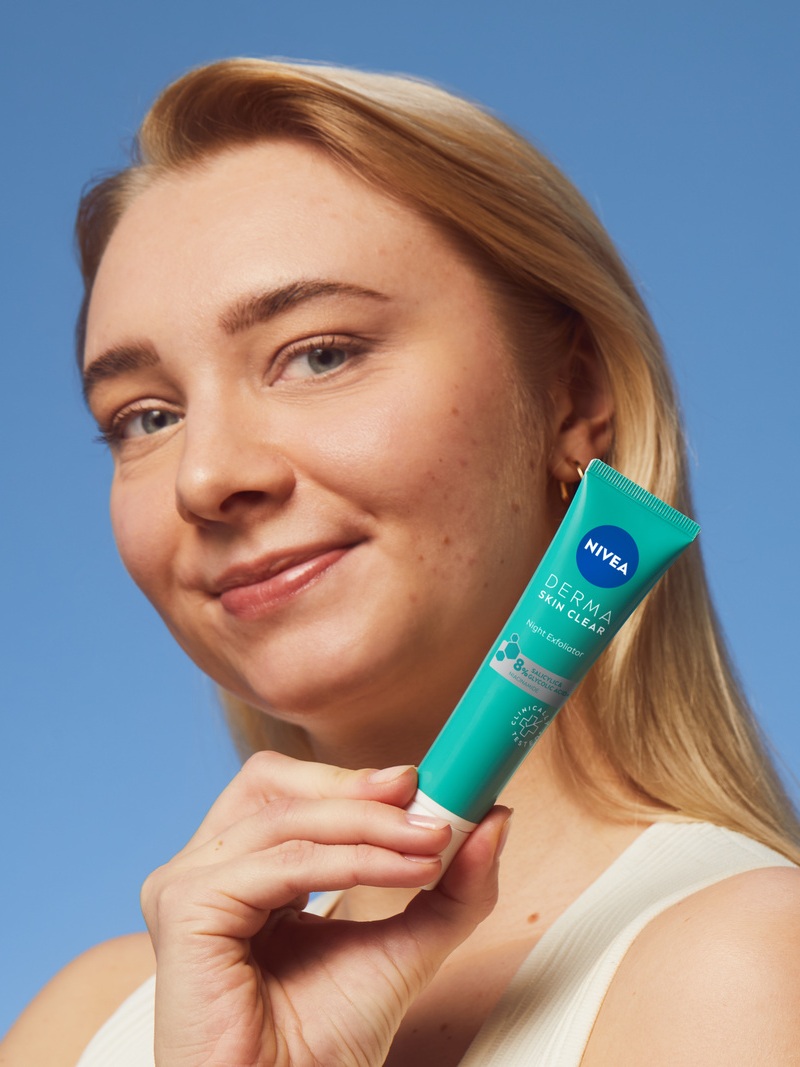 young woman using NIVEA DermaSkin product