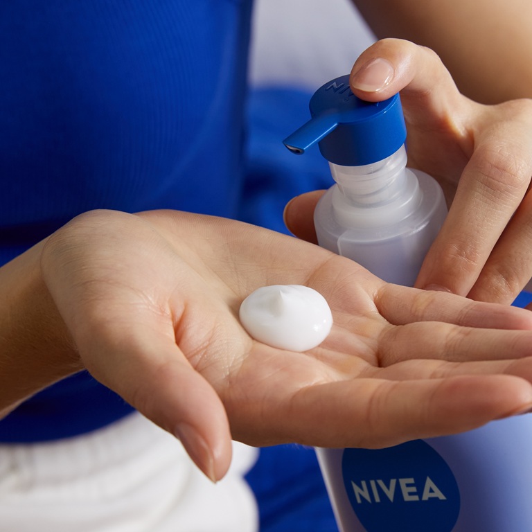 woman applying vegan skincare body lotion