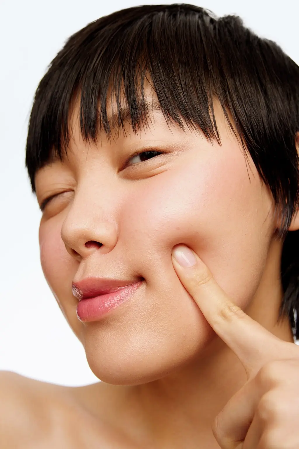 Young woman applying Nivea sun lotion