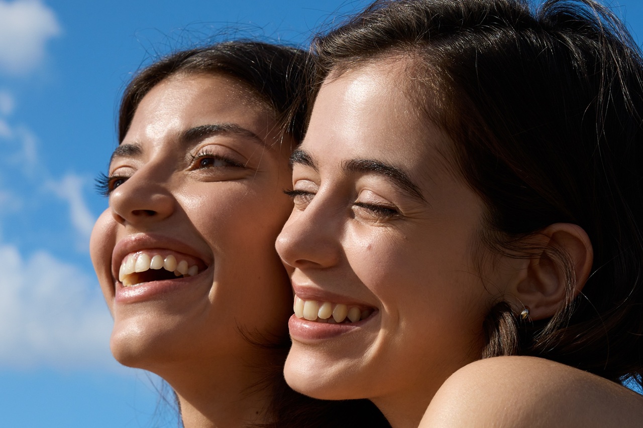 two young girls standing in the sun
