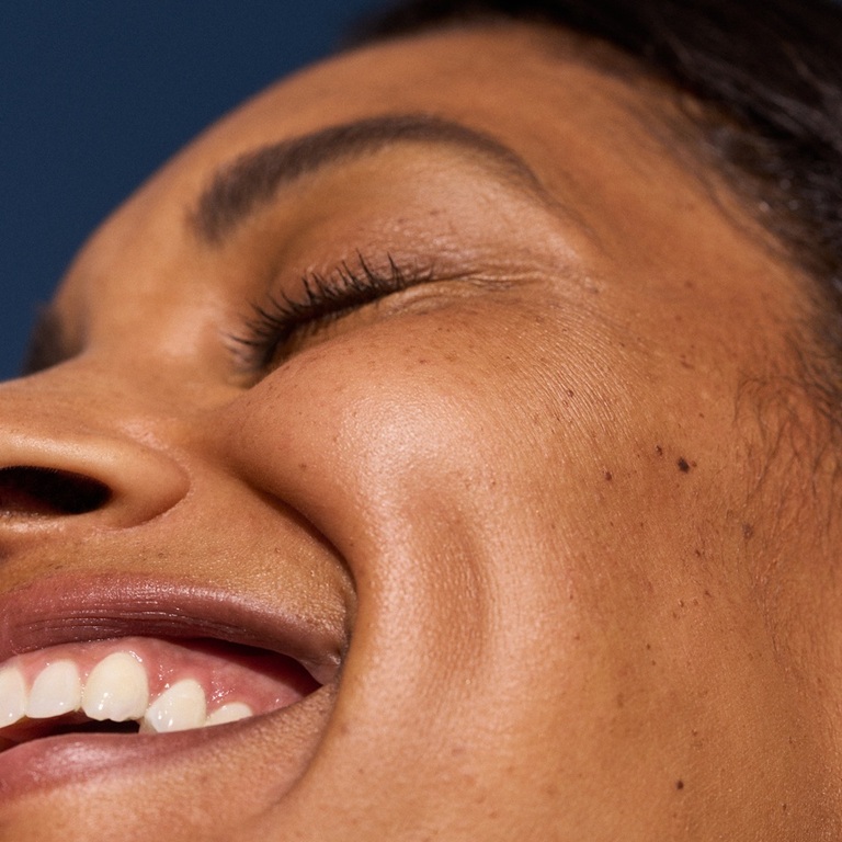 Woman touching face showing skin texture
