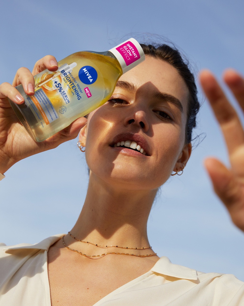 young woman using NIVEA Regenerating Serum Infused Micellar Water