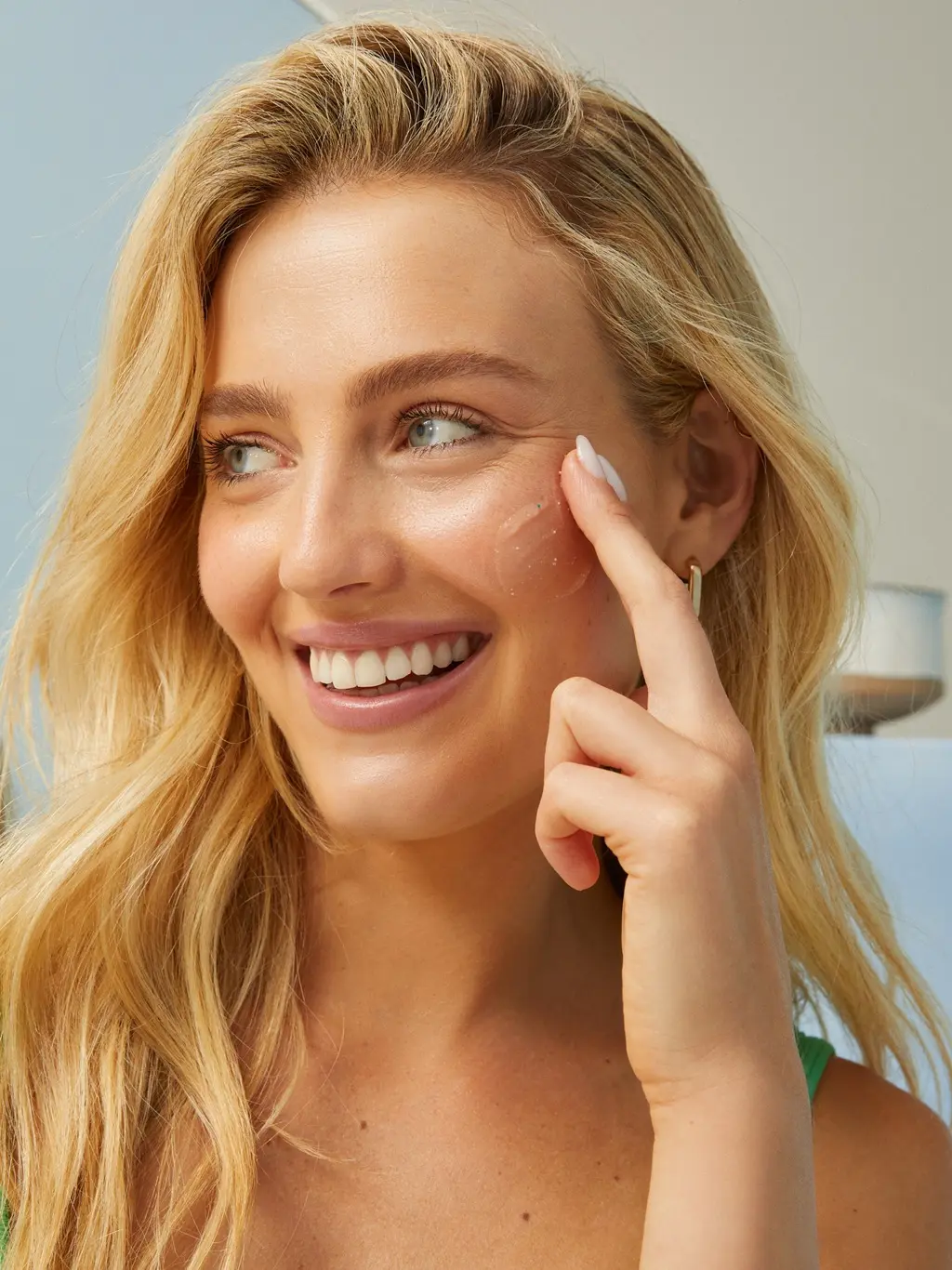 Young woman cleaning her face