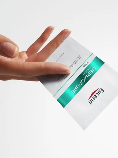 Hand holding the Eucerin Probiom8 Mask
