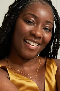 Young black woman using Q10 Firming+ Energising Body Serum-Lotion