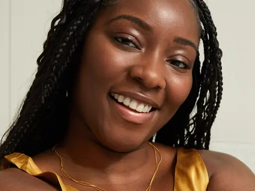 Young black woman using Q10 Firming+ Energising Body Serum-Lotion