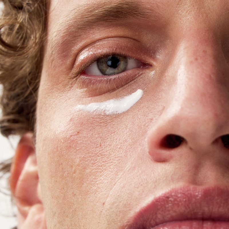 half face of a young man, with cream under his left eye