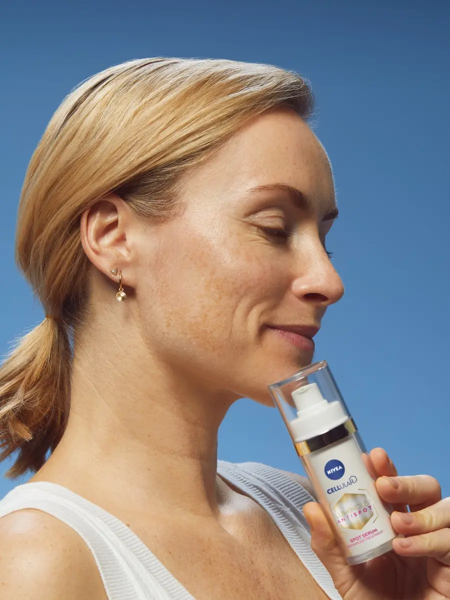 woman using Nivea Cellular Luminous AntiSpot cream