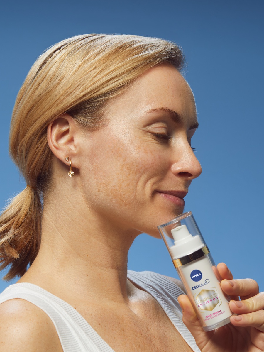woman using Nivea Cellular Luminous AntiSpot cream
