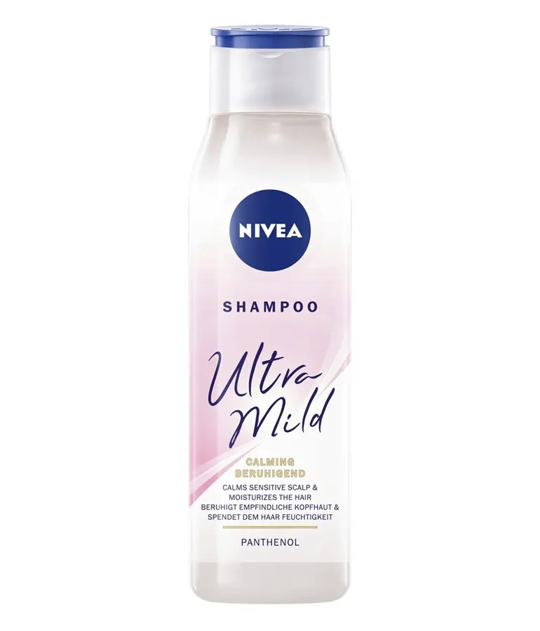 White and pink bottle of NIVEA Ultra Mild Calming shampoo with panthenol and a blue flip-top cap