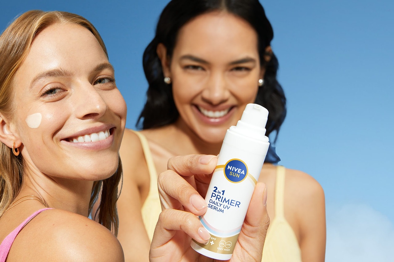 Women smiling and holding NIVEA Sun face Products with UV protection