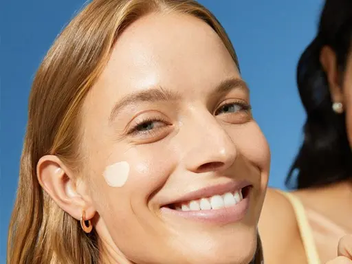 Two Women smiling and holding NIVEA Sun face Products with UV protection